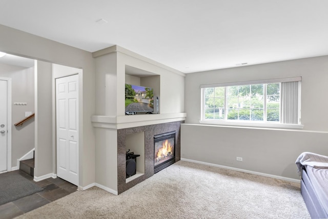 2439 Daybreak Ct Unit 2439, Elgin, IL 60123 - carpeted living room with a tiled fireplace, baseboards, and stairs