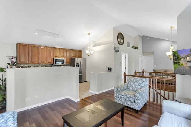 2439 Daybreak Ct Unit 2439, Elgin, IL 60123 - living area with track lighting, wood finished floors, a chandelier, baseboards, and high vaulted ceiling