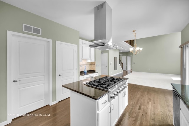 351 Tiger St, Bolingbrook, IL 60490 - kitchen with stainless steel gas stovetop, dark wood-type flooring, a chandelier, island exhaust hood, and white cabinetry