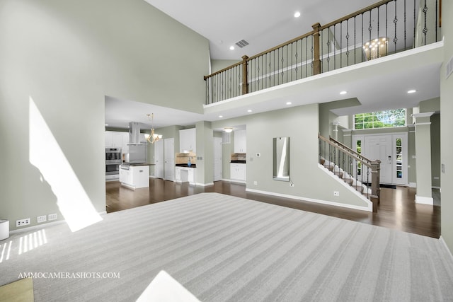 351 Tiger St, Bolingbrook, IL 60490 - living area featuring a high ceiling, stairs, dark wood-type flooring, a chandelier, and baseboards