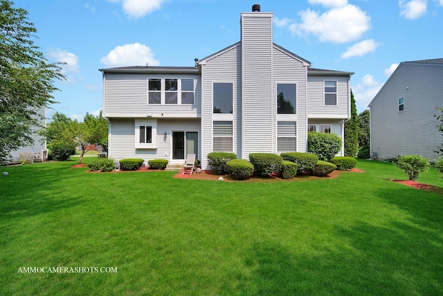 351 Tiger St, Bolingbrook, IL 60490 - rear view of house featuring a lawn, a chimney, and entry steps