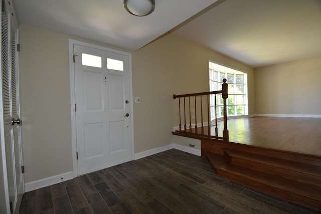 foyer entrance featuring dark wood-style floors and baseboards