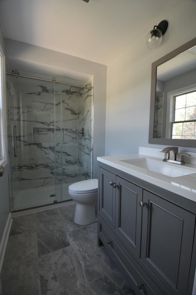 full bath featuring a marble finish shower, vanity, and marble finish floors
