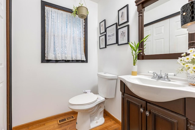 67 Alice St, Algonquin, IL 60102 - bathroom with wood finished floors, vanity, toilet, and baseboards