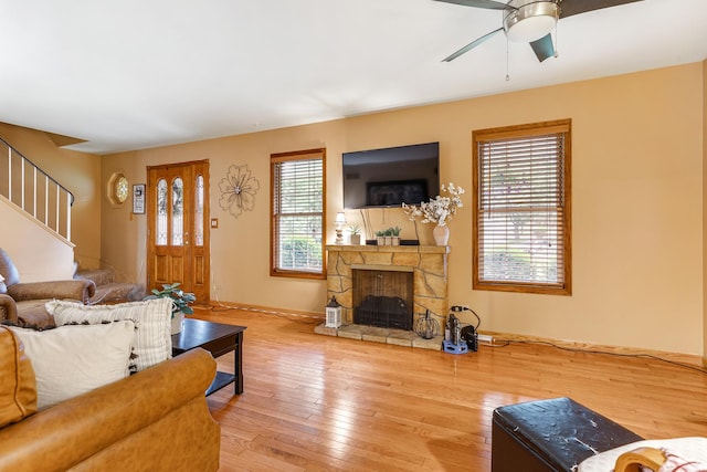 67 Alice St, Algonquin, IL 60102 - living area featuring a fireplace, hardwood / wood-style flooring, stairs, ceiling fan, and baseboards