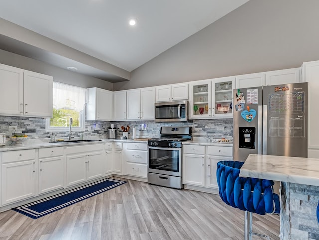 1811 Cumberland Dr, Plainfield, IL 60586 - kitchen featuring stainless steel appliances, a sink, lofted ceiling, white cabinetry, and backsplash