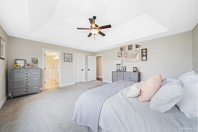 8500 Dungarvan Rd, Frankfort, IL 60423 - bedroom with a raised ceiling, light carpet, baseboards, ceiling fan, and connected bathroom