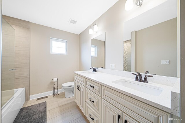 8500 Dungarvan Rd, Frankfort, IL 60423 - bathroom featuring toilet, double vanity, baseboards, and shower / bathtub combination