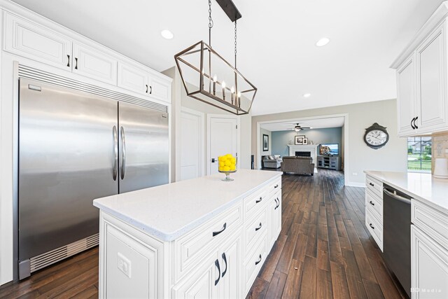 8500 Dungarvan Rd, Frankfort, IL 60423 - kitchen featuring stainless steel appliances, dark wood-style flooring, white cabinetry, a kitchen island, and a chandelier