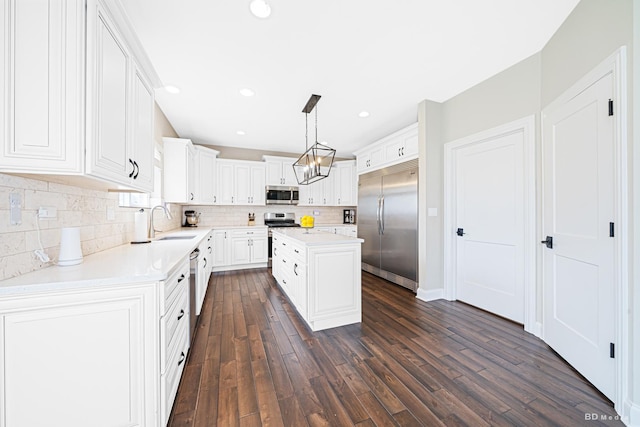 8500 Dungarvan Rd, Frankfort, IL 60423 - kitchen with appliances with stainless steel finishes, a sink, dark wood-type flooring, decorative backsplash, and light countertops