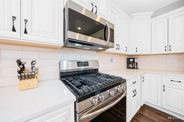 8500 Dungarvan Rd, Frankfort, IL 60423 - kitchen featuring stainless steel appliances, white cabinetry, decorative backsplash, and dark wood finished floors