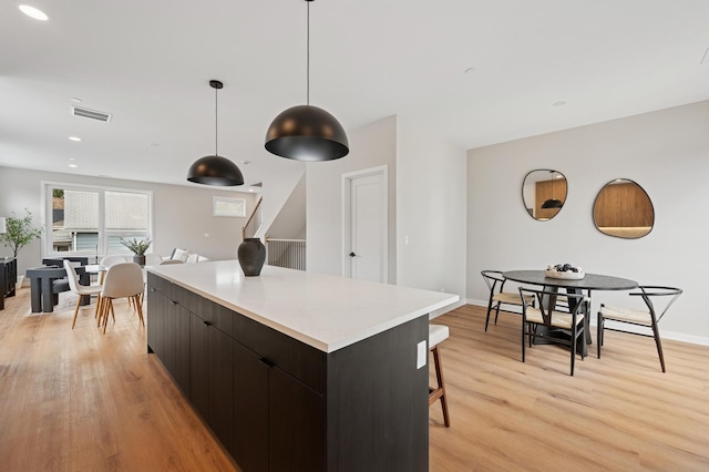 944 Beloit Ave Unit 3, Forest Park, IL 60130 - kitchen with a center island, modern cabinets, light wood-style flooring, pendant lighting, and light countertops