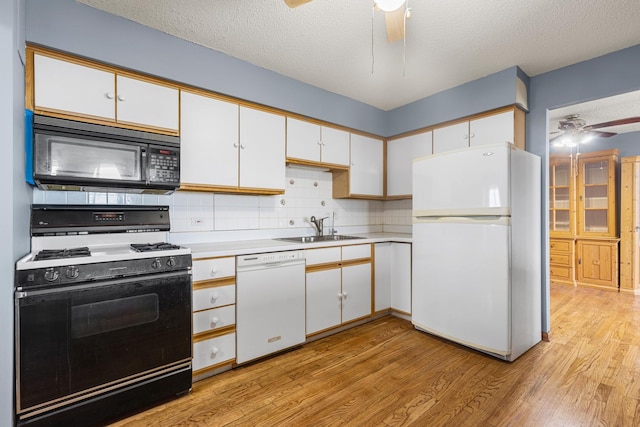 8815 W Golf Rd Unit 7A, Niles, IL 60714 - kitchen featuring white appliances, a ceiling fan, a sink, light wood finished floors, and white cabinets