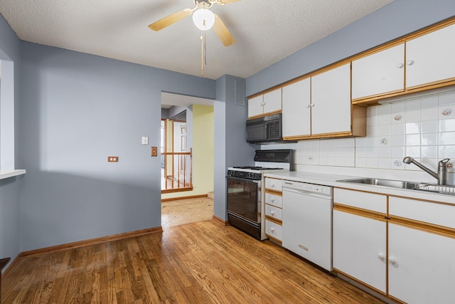 8815 W Golf Rd Unit 7A, Niles, IL 60714 - kitchen featuring range with gas cooktop, white dishwasher, black microwave, white cabinets, and light wood-style floors
