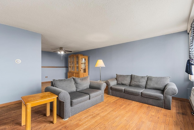 8815 W Golf Rd Unit 7A, Niles, IL 60714 - living area featuring ceiling fan, wood finished floors, a textured ceiling, and baseboards