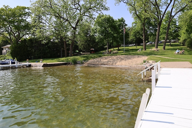 N2335 Main Rd, Lake Geneva, WI 53147 - dock featuring view of wooded area, a water view, and a yard