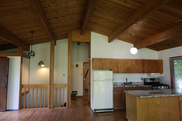 N2335 Main Rd, Lake Geneva, WI 53147 - kitchen with freestanding refrigerator, stainless steel range with gas cooktop, a sink, under cabinet range hood, and brown cabinetry