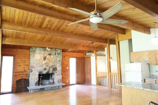 N2335 Main Rd, Lake Geneva, WI 53147 - unfurnished living room featuring healthy amount of natural light, ceiling fan, wooden ceiling, wood finished floors, and a stone fireplace