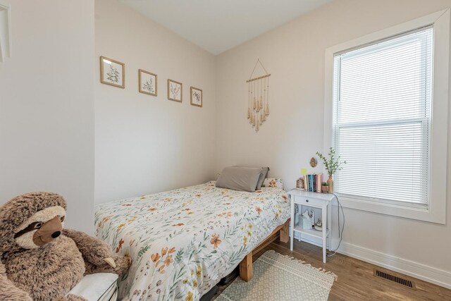3331 S Ashland Ave, Chicago, IL 60608 - bedroom featuring wood finished floors, multiple windows, and baseboards