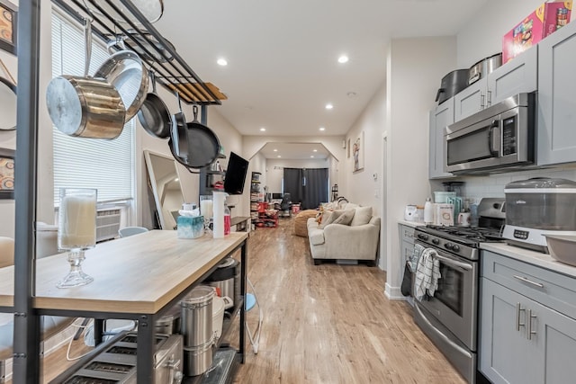 3331 S Ashland Ave, Chicago, IL 60608 - kitchen featuring stainless steel appliances, light wood-style floors, recessed lighting, gray cabinetry, and backsplash