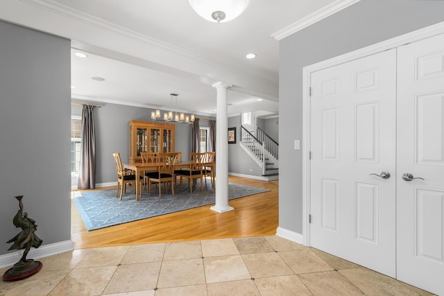 6972 W Imlay St, Chicago, IL 60631 - dining room with crown molding, decorative columns, light tile patterned floors, a chandelier, and stairway