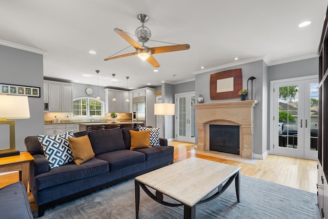 6972 W Imlay St, Chicago, IL 60631 - living room featuring recessed lighting, french doors, light wood-style flooring, ceiling fan, and a fireplace with flush hearth