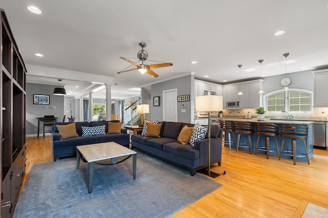 6972 W Imlay St, Chicago, IL 60631 - living area featuring light wood-style flooring, ceiling fan, ornamental molding, recessed lighting, and stairway