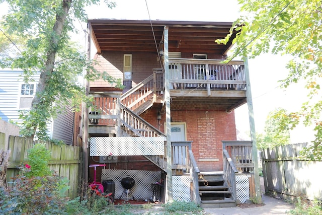 727 N Springfield Ave, Chicago, IL 60624 - back of house with stairs, brick siding, and a wooden deck