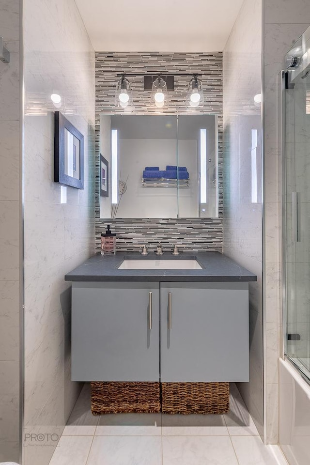 2400 N Lakeview Ave Unit 1706, Chicago, IL 60614 - bathroom featuring vanity, a shower with door, tile walls, and tile patterned floors