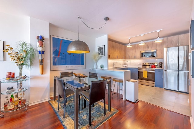 2400 N Lakeview Ave Unit 1706, Chicago, IL 60614 - dining space featuring rail lighting and wood finished floors