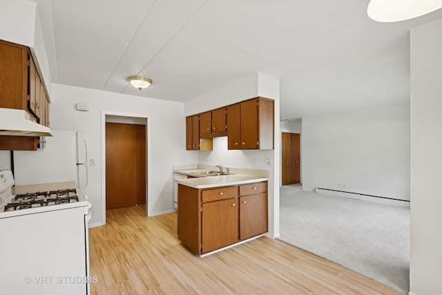 801 E Miner St Unit 1A, Arlington Heights, IL 60004 - kitchen with white range with gas cooktop, under cabinet range hood, baseboard heating, and brown cabinetry