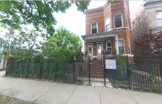 741 N Christiana Ave, Chicago, IL 60624 - view of front of property with a fenced front yard and covered porch