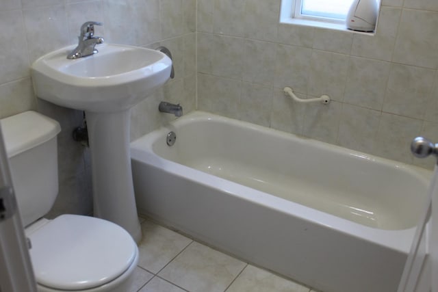 741 N Christiana Ave, Chicago, IL 60624 - bathroom featuring toilet, tile patterned flooring, tile walls, and shower / washtub combination
