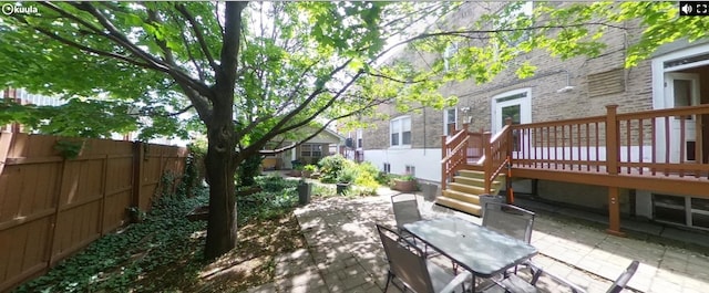 741 N Christiana Ave, Chicago, IL 60624 - fenced backyard featuring a patio, outdoor dining area, a wooden deck, and stairs