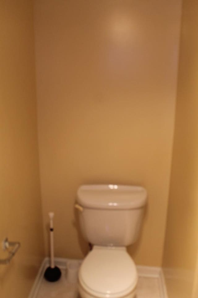 741 N Christiana Ave, Chicago, IL 60624 - bathroom with tile patterned floors, toilet, and baseboards