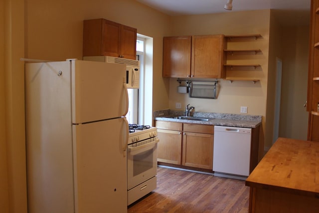 741 N Christiana Ave, Chicago, IL 60624 - kitchen featuring white appliances, light wood-style flooring, a sink, open shelves, and brown cabinets