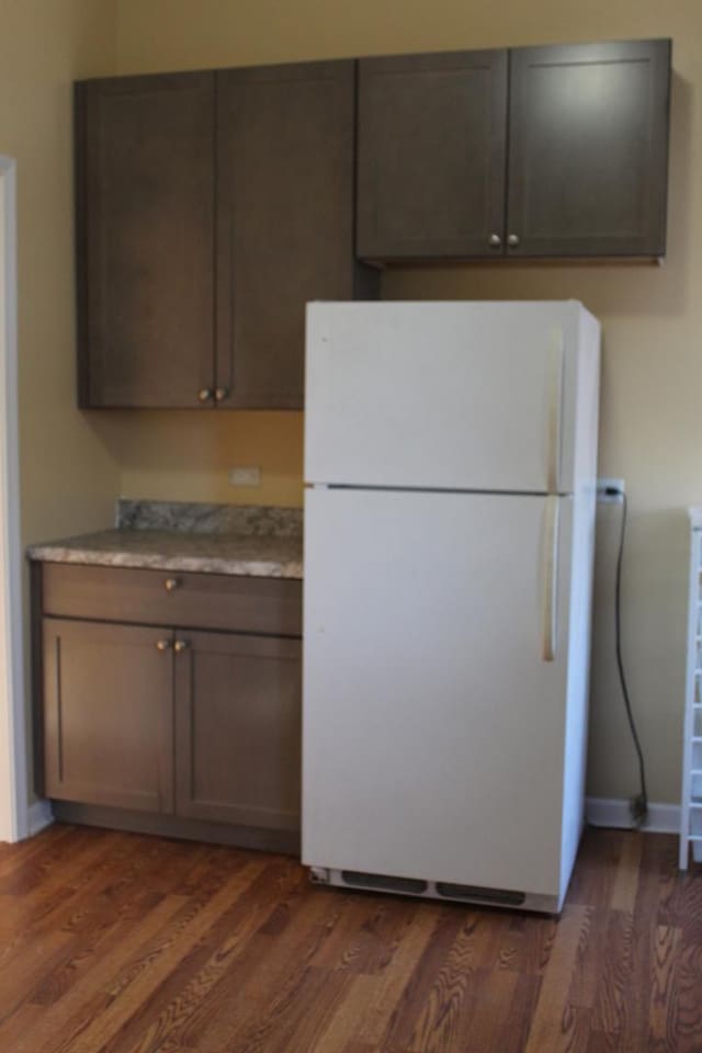 741 N Christiana Ave, Chicago, IL 60624 - kitchen with freestanding refrigerator, dark wood-type flooring, light countertops, and baseboards