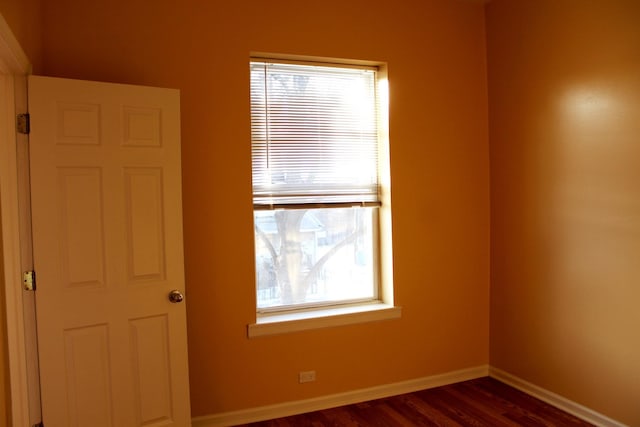 741 N Christiana Ave, Chicago, IL 60624 - unfurnished room featuring plenty of natural light, dark wood-style flooring, and baseboards
