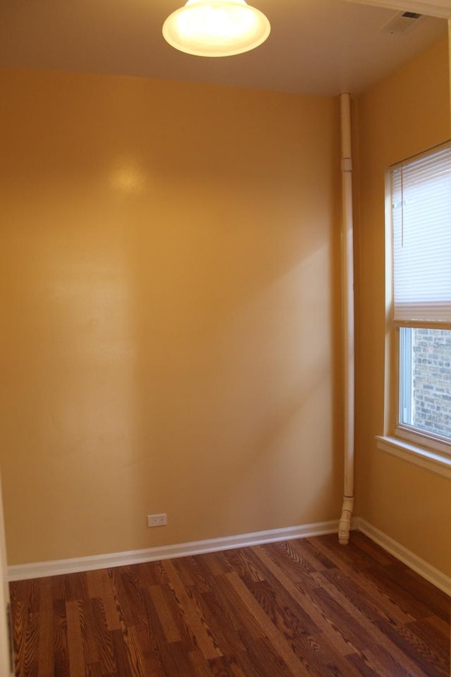 741 N Christiana Ave, Chicago, IL 60624 - unfurnished room featuring dark wood-type flooring and baseboards