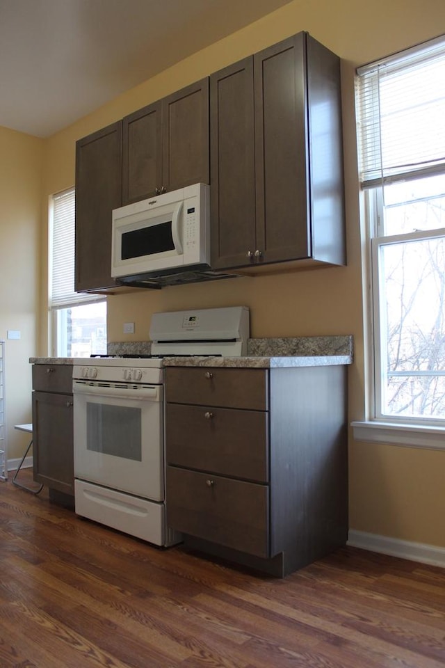 741 N Christiana Ave, Chicago, IL 60624 - kitchen featuring white appliances, dark wood finished floors, baseboards, and dark brown cabinets