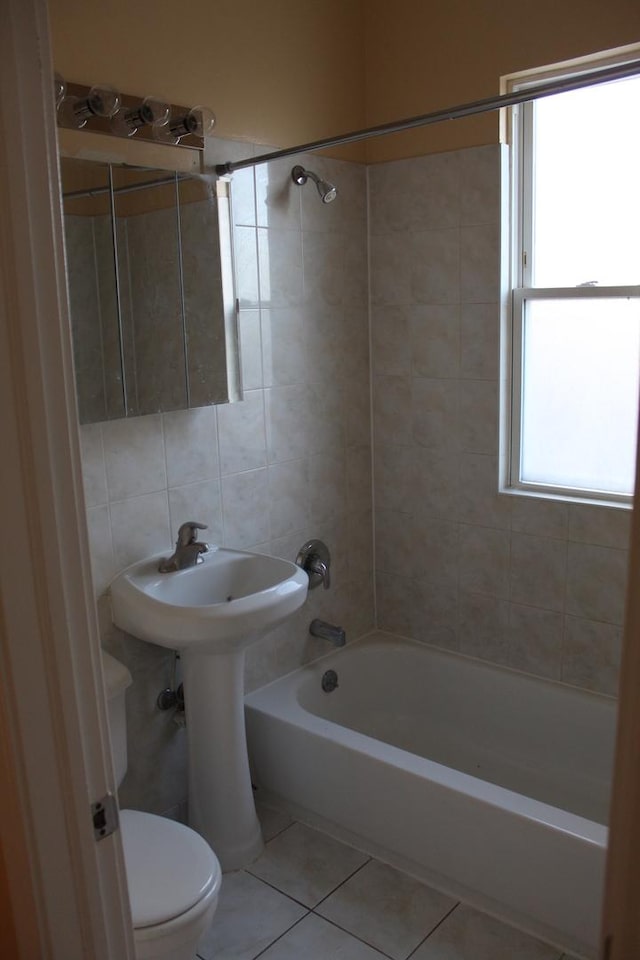 741 N Christiana Ave, Chicago, IL 60624 - full bathroom with toilet, tile patterned flooring, washtub / shower combination, tile walls, and a sink