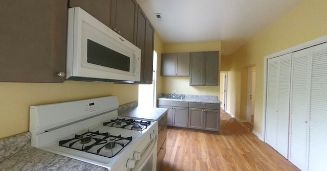 741 N Christiana Ave, Chicago, IL 60624 - kitchen featuring white appliances, light wood-type flooring, light countertops, and gray cabinetry