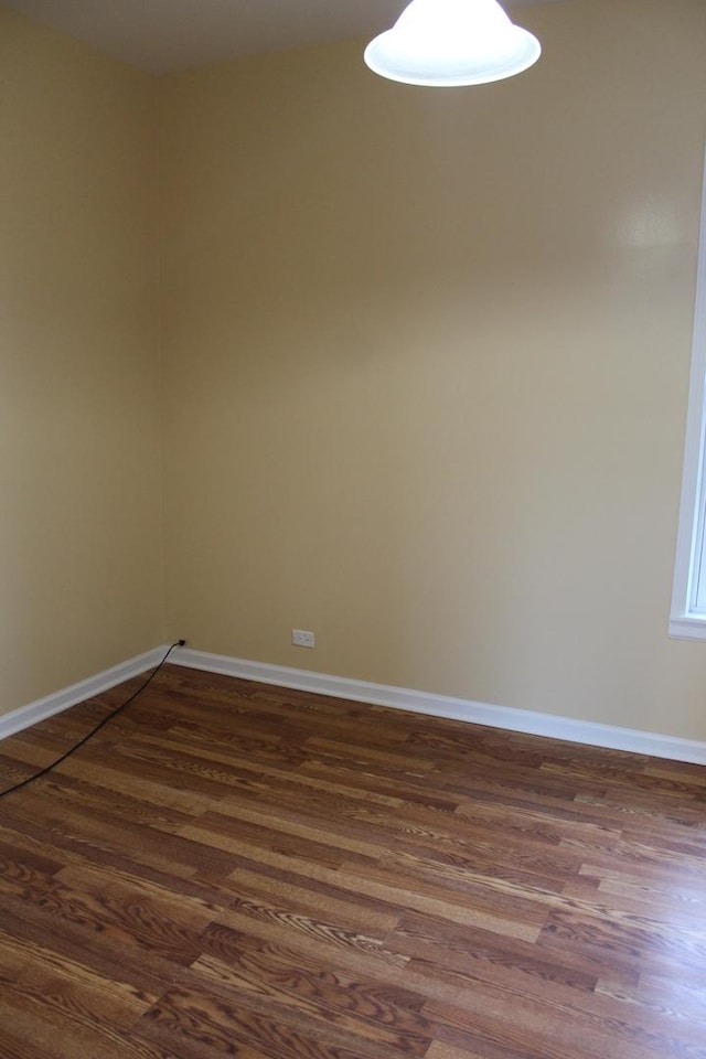 741 N Christiana Ave, Chicago, IL 60624 - unfurnished room with dark wood-style flooring and baseboards