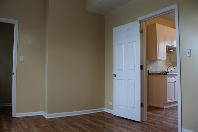 741 N Christiana Ave, Chicago, IL 60624 - unfurnished bedroom with dark wood-style floors and baseboards