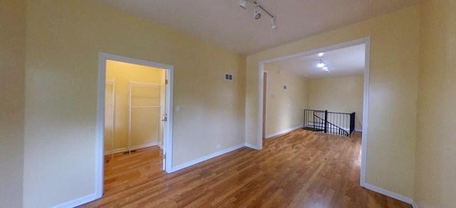 741 N Christiana Ave, Chicago, IL 60624 - unfurnished room featuring wood finished floors and track lighting