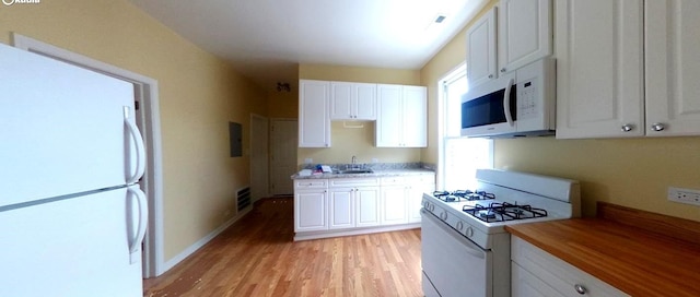 741 N Christiana Ave, Chicago, IL 60624 - kitchen featuring white appliances, light wood finished floors, white cabinets, and butcher block counters