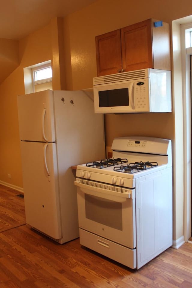 741 N Christiana Ave, Chicago, IL 60624 - kitchen with white appliances, light wood-type flooring, baseboards, and brown cabinets