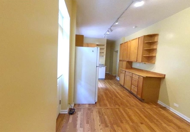 741 N Christiana Ave, Chicago, IL 60624 - kitchen featuring freestanding refrigerator, open shelves, light wood finished floors, brown cabinets, and track lighting