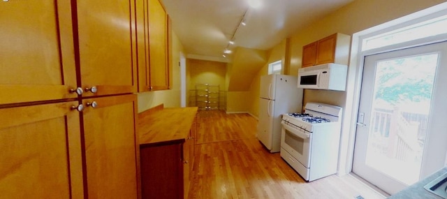 741 N Christiana Ave, Chicago, IL 60624 - kitchen featuring white appliances, light wood-style floors, track lighting, and brown cabinetry