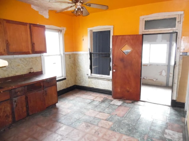 1434 W 72nd Pl, Chicago, IL 60636 - kitchen with a ceiling fan, brown cabinets, and baseboards